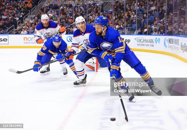 Jordan Greenway of the Buffalo Sabres skates with the puck against Evan Bouchard of the Edmonton Oilers during an NHL game on March 6, 2023 at...