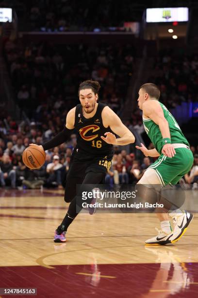 Cedi Osman of the Cleveland Cavaliers dribbles the ball during the game against the Boston Celtics on March 6, 2023 at Rocket Mortgage FieldHouse in...