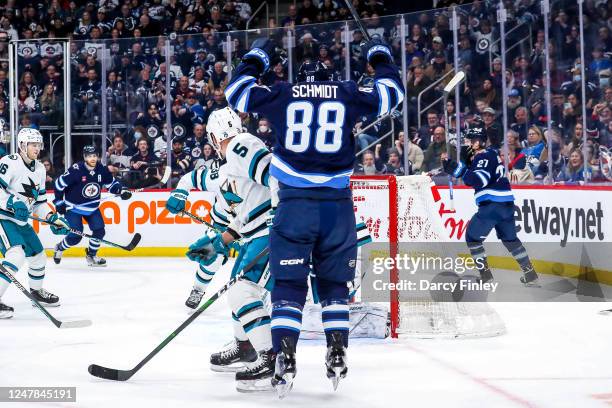 Nate Schmidt of the Winnipeg Jets raises his arms in celebration after scoring a third period goal against the San Jose Sharks at the Canada Life...