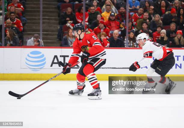 Ottawa Senators center Shane Pinto skates against Chicago Blackhawks defenseman Connor Murphy during a game between the Ottawa Senators and the...