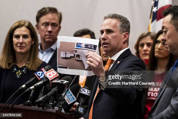 Jeremy Stein, executive director of CT Against Gun Violence , holds up a photo of plastic, 3D-printed gun that was recovered from a Waterbury man in...