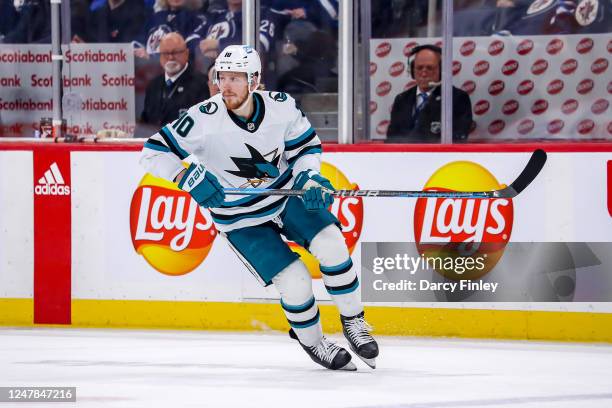 Evgeny Svechnikov of the San Jose Sharks keeps an eye on the play during third period action against the Winnipeg Jets at the Canada Life Centre on...