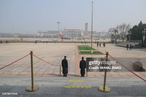 Security officers stand guard outside the Great Hall of the People ahead of the second plenary session of the National People's Congress in Beijing...