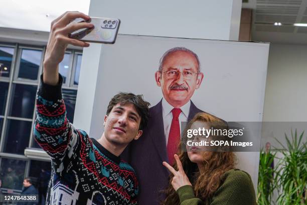 Young couple takes a selfie in front of Chairman Kemal Klçdarolu poster, also a presidential candidate for Republican People's Party . The Republican...