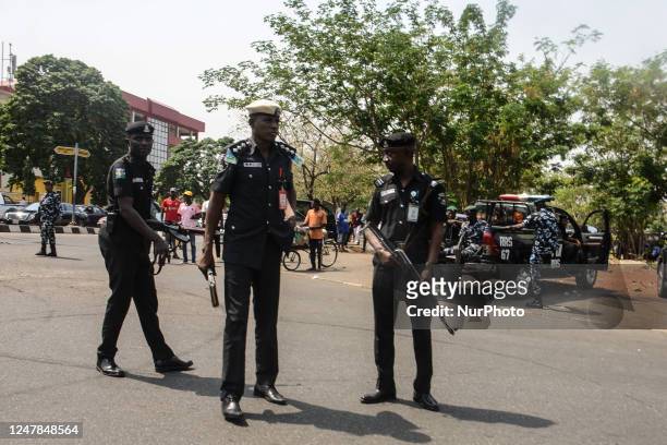Security officials look on at the venue where People's Democratic Party protest at Independent National Electoral Commission , protesting on the...