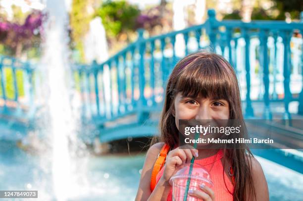 cute girl drinking cocktail to park - drinking straw stock pictures, royalty-free photos & images