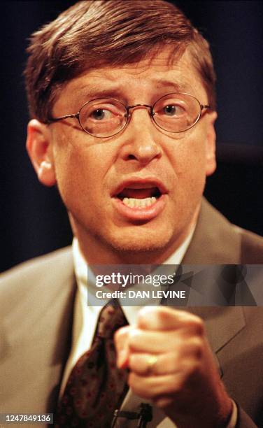 Microsoft co-founder and chairman Bill Gates clenches his fist during a press conference 18 May in Redmond, Washington state, while defining his...