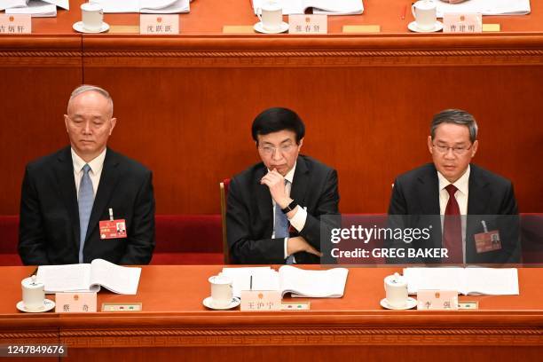 Politburo Standing Committee members Cai Qi, Wang Huning and Li Qiang attend the second plenary session of the National People's Congress at the...