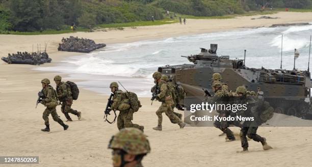 Japan Ground Self-Defense Force members land by an amphibious vehicle on the shore of Tokunoshima Island in Kagoshima Prefecture, southwestern Japan,...