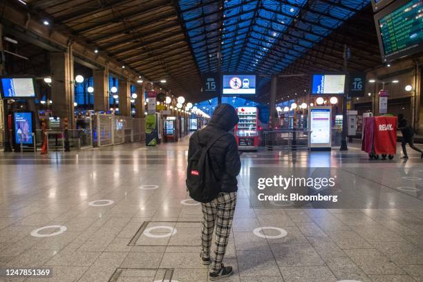 Traveler waits at an empty Gare du Nord train station during limited rail services due to a national strike against pension reform, in Paris, France,...