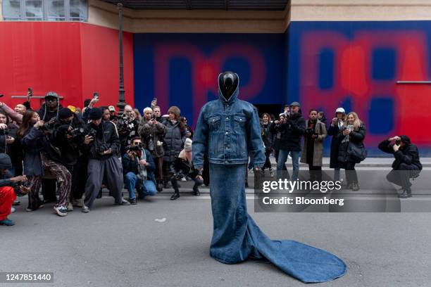 Media influencers photograph an attendee outside the venue for the Balenciaga Fall/Winter 2023 fashion show during Paris Fashion Week in Paris,...