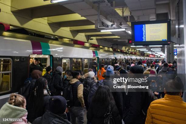 Crowds of passengers alight an RER subway train at Gare du Nord train station during limited rail services due to a national strike against pension...