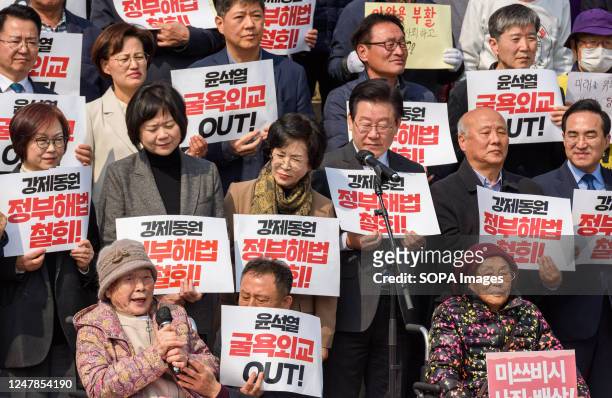 South Korean forced labor victims Kim Sung-ju speaks with Yang Geum-deok during a rally against the South Korean government's announcement of a plan...