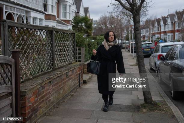 Ukrainian refugee Anna Shchekan walks to the underground station as she leaves her host family's home to go to work on March 3, 2023 in London,...