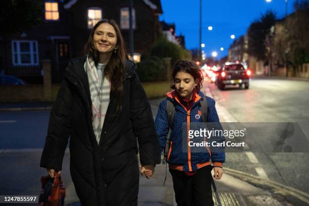 Ukrainian refugee Yevhenia Shymshyrian walks home with her 10-year-old son Gregory after collecting him from school on March 6, 2023 in London,...