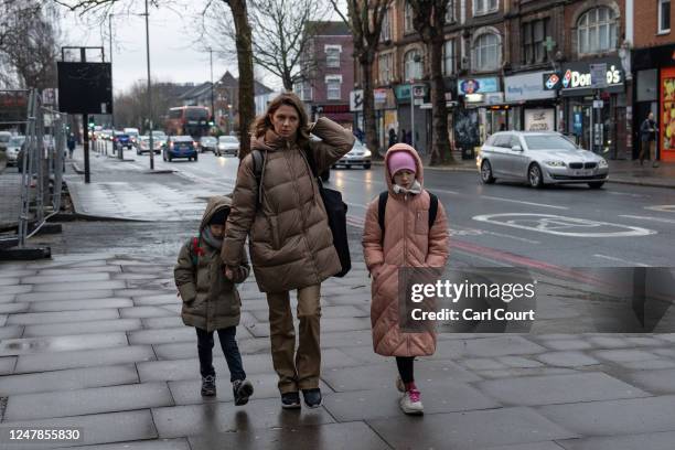 Ukrainian refugee Iryna Nadtochii walks to the train station with her children, 5-year-old Andrii, and 10-year-old Viktoriia as she takes them to...