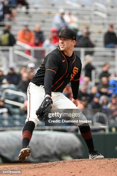 Kyle Harrison of the San Francisco Giants throws a pitch during the sixth inning of a spring training game against the Arizona Diamondbacks at...