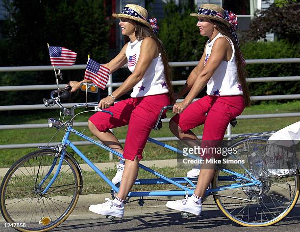 Twins Patty Sermerscheim and Peggy Meyer, of Jasper Indiana, ride in the Double Take Parade August 3, 2002 at the Twins Days Festival in Twinsburg,...