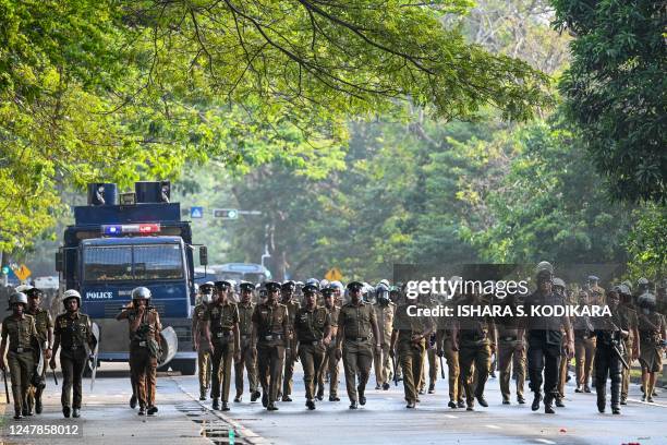 Policemen march during a protest by anti-government demonstrators and university students demanding the release of Inter University Students'...