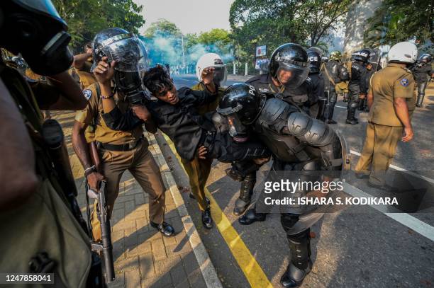 Policemen carry an injured colleague during a protest by anti-government demonstrators and university students demanding the release of Inter...