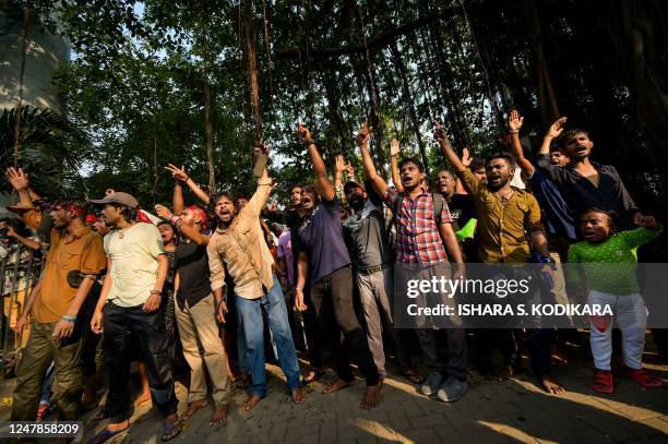 Anti-government demonstrators and university students shout slogans as they take part in a protest demanding the release of Inter University...