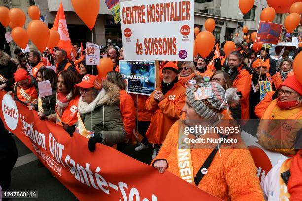 French hospital center employees take part in a demonstration in Paris on March 7 as part of a nationwide day of strikes and protests called by...