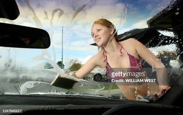 Laurie Ann wipes away the suds from the windscreen at Kittens Car Wash in the Melbourne suburb of Bentleight East, which faces closure as the local...
