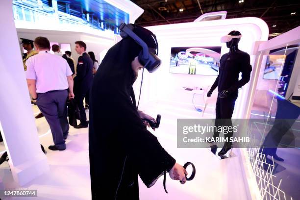 Woman tries on a virtual reality set during the World police Summit 2023 in Dubai on March 7, 2023.