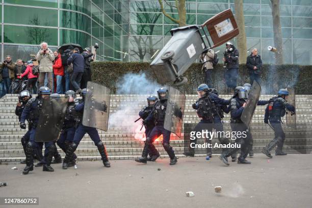 Riot police engage during clashes with protesters in a rally against French President's plan to raise the legal retirement age from 62 to 64 in...