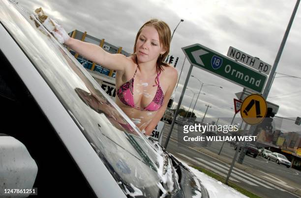 Laurie Ann wipes away the suds from the windscreen at Kittens Car Wash in the Melbourne suburb of Bentleight East on May 21, 2008 which faces closure...