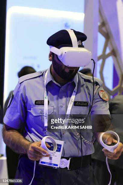 Policeman tries on a virtual reality set during the World police Summit 2023 in Dubai on March 7, 2023.