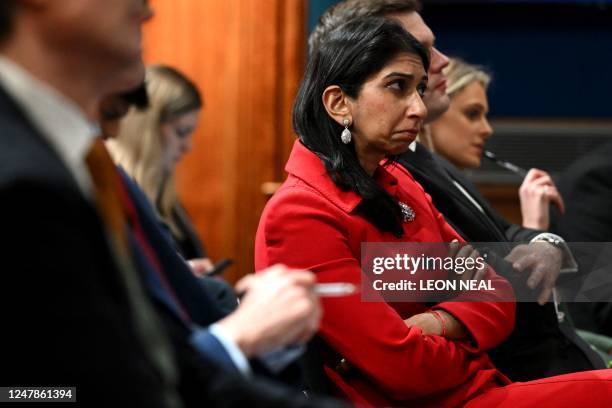 Britain's Home Secretary Suella Braverman listens as Britain's Prime Minister Rishi Sunak speaks during a press conference in the Downing Street...