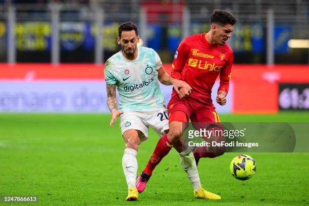 Hakan Calhanoglu of Inter Milan and Pietro Ceccaroni of US Lecce battle for the ball during the Serie A match between FC Internazionale and US Lecce...