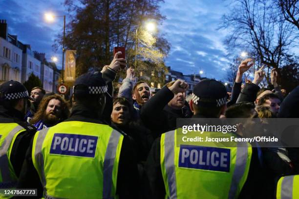 Chelsea fans press up against a line of police as they wait for the arriving Dortmund fans ahead of the UEFA Champions League round of 16 leg two...