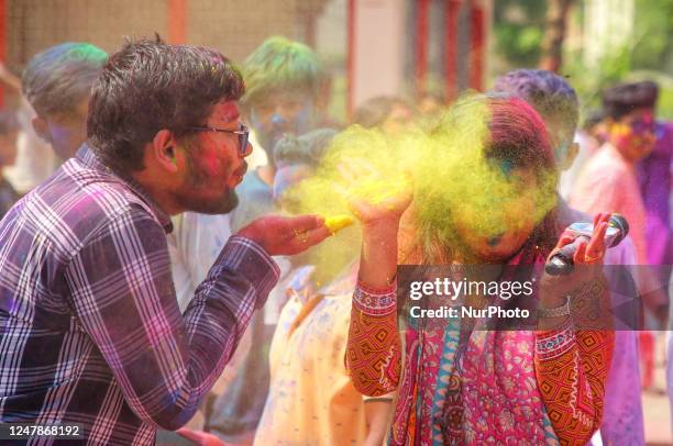 People spread abir celebrating Dol Purnima festival at Dhakeshwari national temple in Dhaka, Bangladesh, on 07 March 2023.