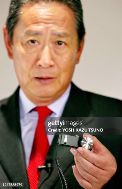 Japan's electronics giant Sony Chairman and CEO Nobuyuki Idei shows off the new micro sized digital still camera "QUALIA QO16-WE1", equipped with a...