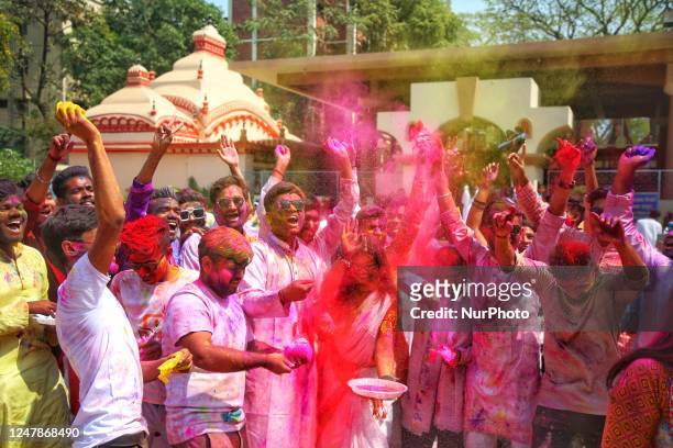 People spread abir celebrating Dol Purnima festival at Dhakeshwari national temple in Dhaka, Bangladesh, on 07 March 2023.