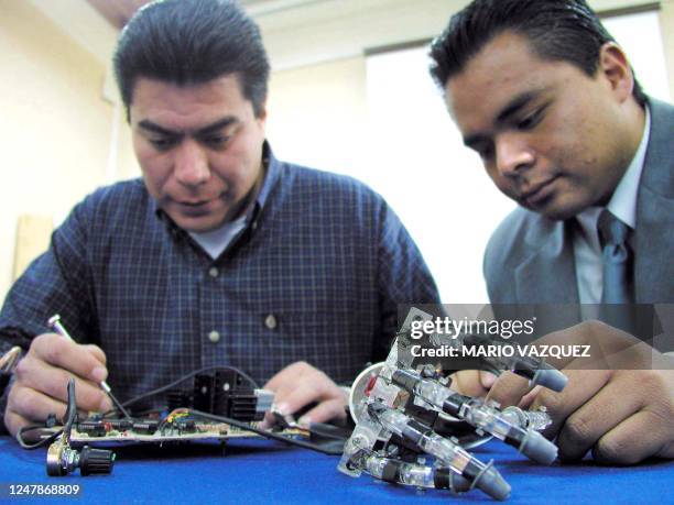 Engineers Jimenez Garcia and Noel Guillermo Rodriguez Linas are seen presenting their prosthetic hand in Metepec, Mexico 19 February 2002. Los...