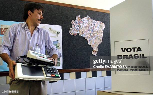 An electoral official carries an electronic ballot counter 26 October 2002, on the eve of the presidential run-off. Some 115 million electors will...