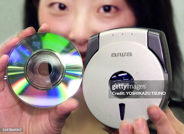 Japanese audio maker Aiwa employee, Chieko Minami displays the new 8cm portable CD player XP-Z3 with MP3 decoder to play 8cm CD-R/RW in MP3 format...