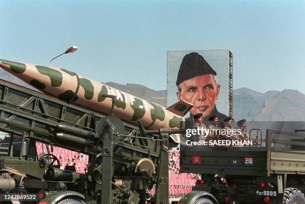 Pakistan's made surface-to-air missile "Hattaf" passes 21 March 1997 in Islamabad by a huge portrait of the founder of Pakistan Mohammad Ali Jinnah...