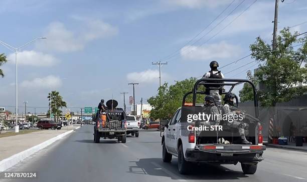 National Guard and military vehicles take part in an operation to transfer two of the four US citizens kidnapped in Mexico's crime-ridden northeast,...