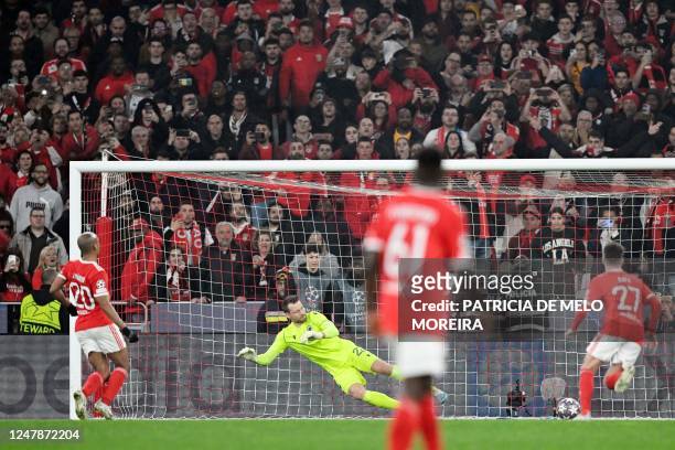Benfica's Portuguese midfielder Joao Mario scores his team's fourth goal from the penalty spot during the UEFA Champions League round of 16 second...