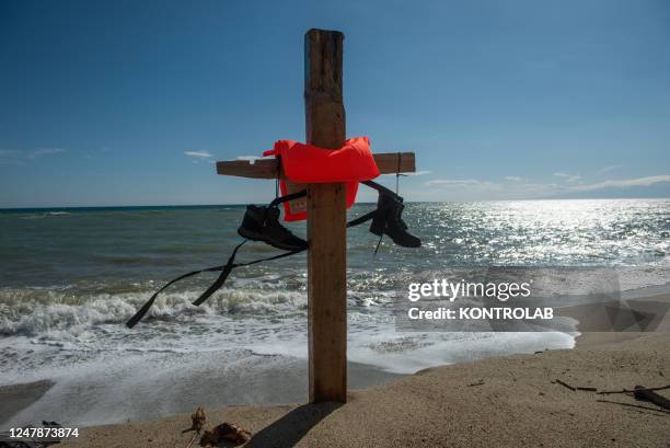 Detail of a cross made with the pieces of the migrant boat that sank on February 26 and with a life jacket of the people on board, placed on the...