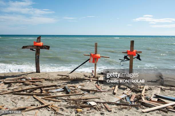 Some crosses made with the pieces of the migrant boat that sank on February 26 and with the life jackets of the people on board, placed on the beach....