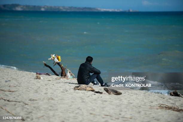 Relative of a migrant who went missing after the tragedy of the migrant boat that sank on February 26, sits on the beach. In the shipwreck off the...