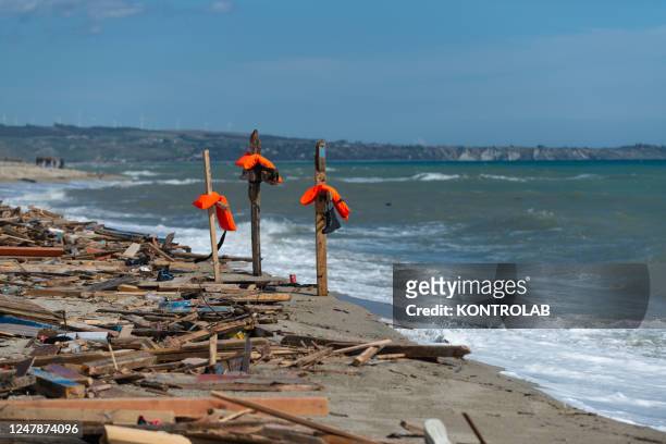 Some crosses made with the pieces of the migrant boat that sank on February 26 and with the life jackets of the people on board, placed on the beach....