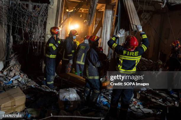 Firefighters and rescue workers search for survivors and bodies at the site of an explosion in a multi storey building at Gulisthan in Dhaka. At...