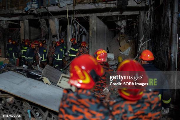 Firefighters and rescue workers search for survivors and bodies at the site of an explosion in a multi storey building at Gulisthan in Dhaka. At...