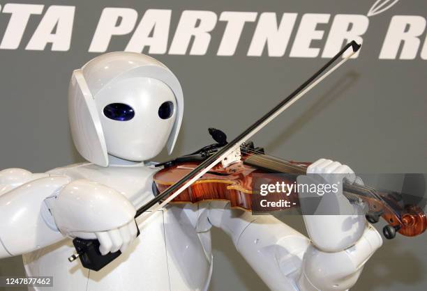 Japanese auto giant Toyota Motor unveils their new violin-playing robot at the company's showroom in Tokyo, 06 December 2007. Toyota unveiled three...